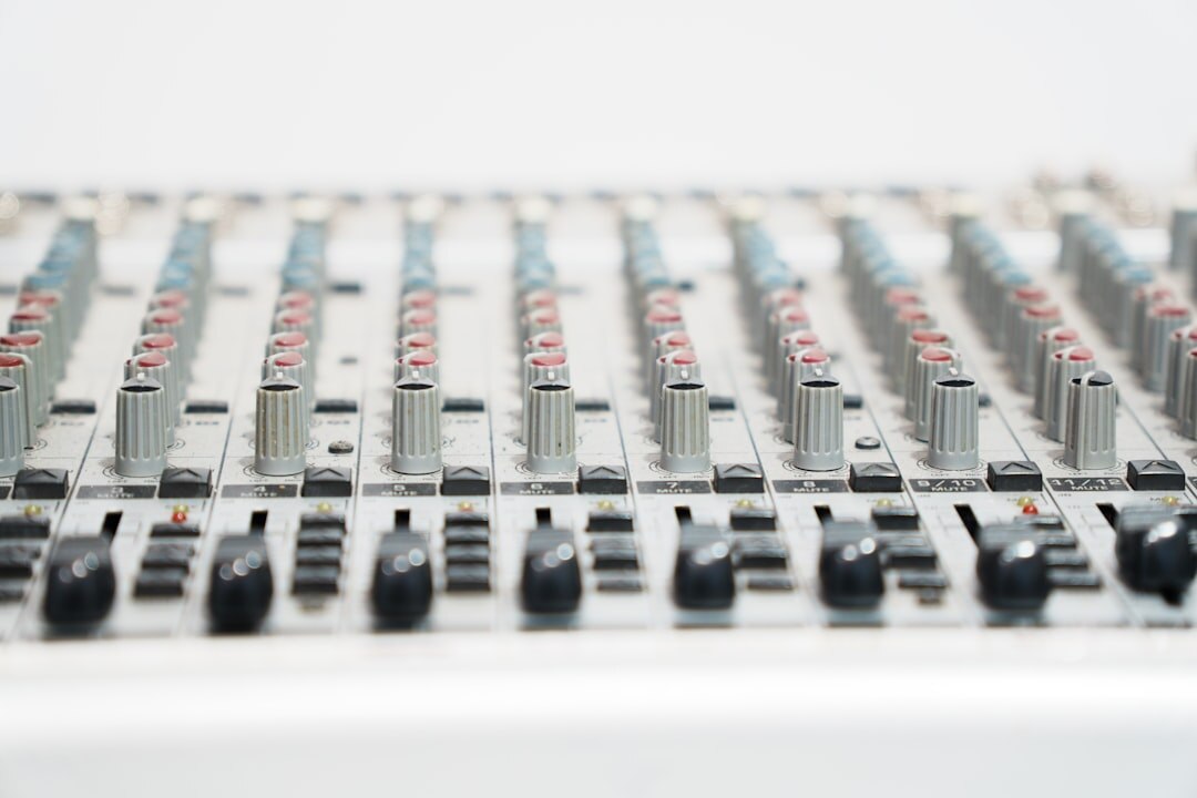 Professional audio mixing board with faders and knobs